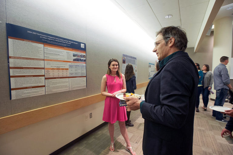 IS student discusses her research with IS professor. 