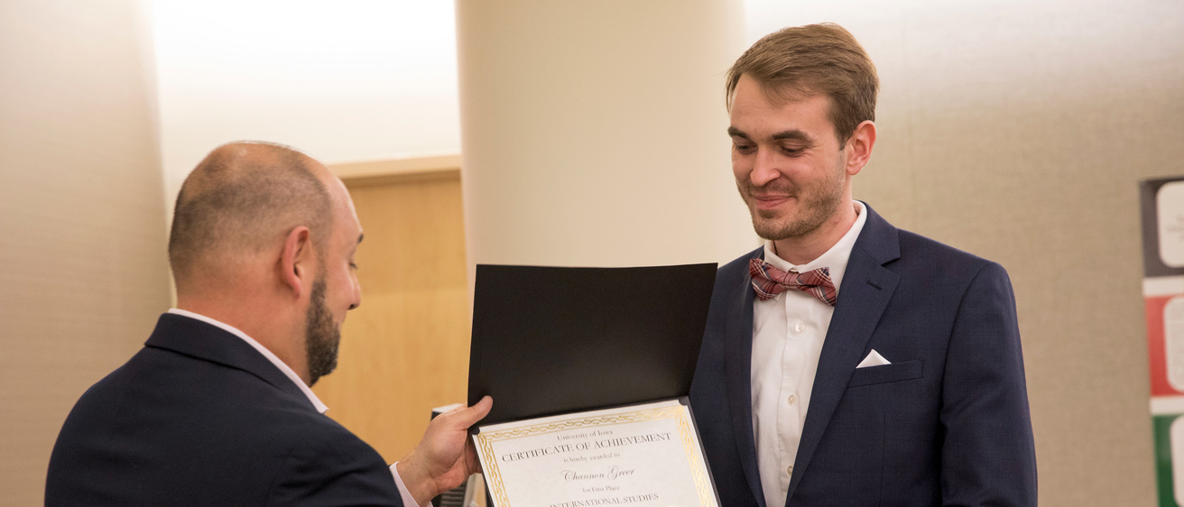 An Honors student receiving an award at a Honors poster session.