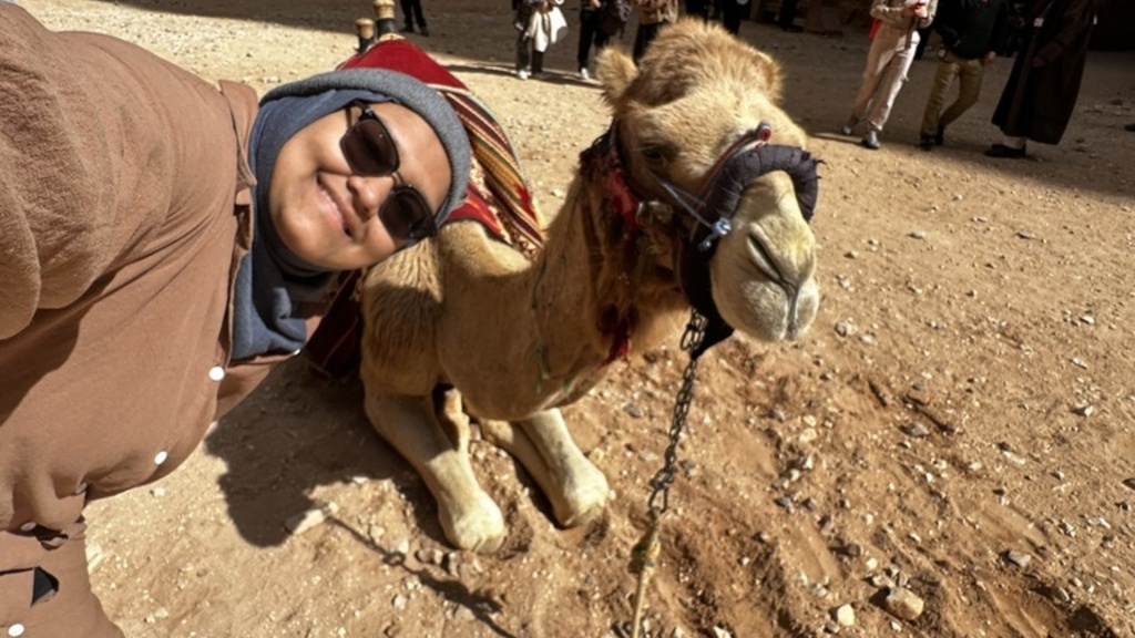 Maryam Mohammed poses with camel in Jordan
